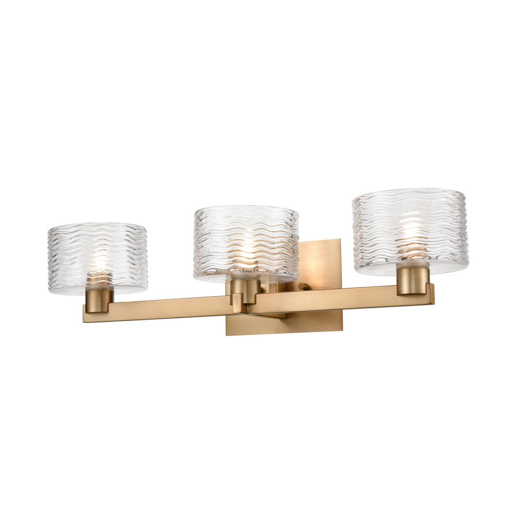 Percussion Three Light Vanity in Brass With Ripple Glass - available from The Lighting Shoppe, trusted by Canadian homeowners