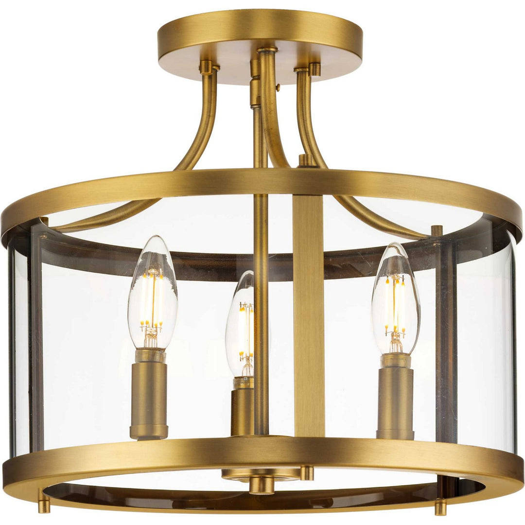 Gilliam Three Light Semi Flush Mount in Vintage Brass - available from The Lighting Shoppe, trusted by Canadian homeowners