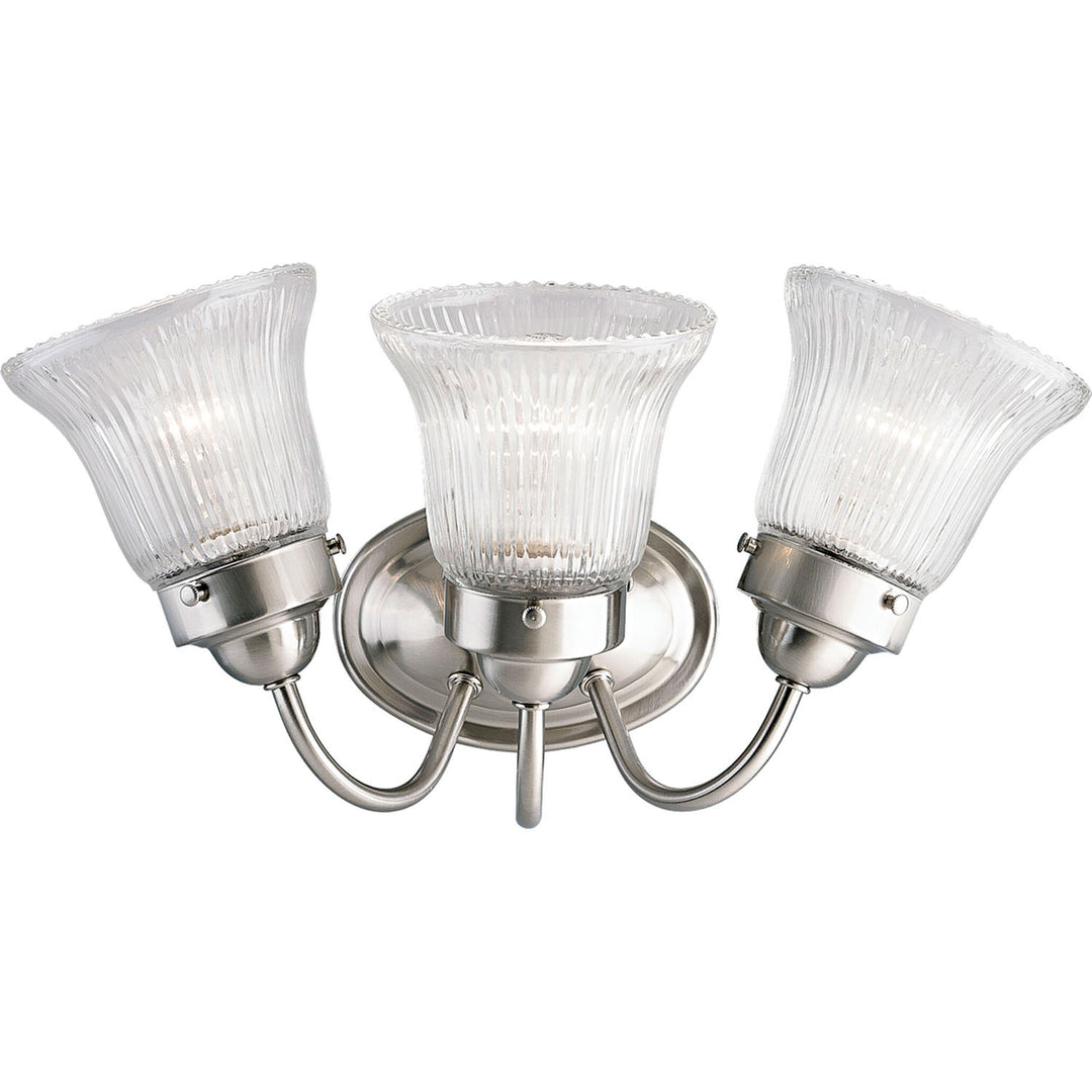 Fluted Glass-Clear Three Light Bath Bracket in Brushed Nickel - available from The Lighting Shoppe, trusted by Canadian homeowners